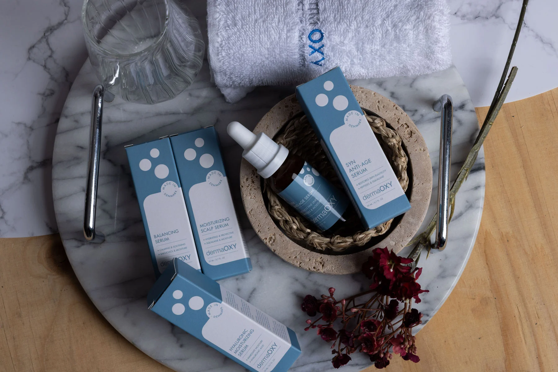 DermaOxy products and merchandise scattered around 